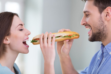 Wall Mural - Couple Sharing Sandwich
