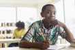 © JGI/Tom Grill/Blend Images - Male student thinking in classroom