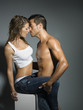 erotic scene of a sexy couple in jeans having sex