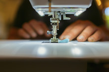 Close Up Of Dressmaker Using Sewing Machine
