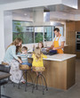 © Sam Diephuis/Blend Images - Caucasian family cooking in kitchen