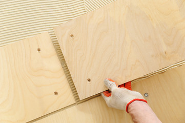 Laying plywood on the floor.