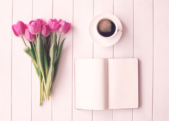 Wall Mural - Pink tulips, coffee cup and notebook over white wood