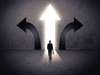 Businessman in front of three arrows