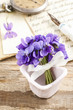Bouquet of violet flowers (viola odorata) and paper card