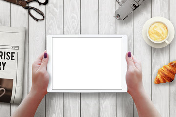 Aufkleber - Tablet with isolated screen in woman hands. Morning time with newspaper, croissant, coffee on table.
