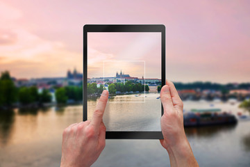 Leinwandbilder - Photographing city landscape with tablet. Tourists holding a black tablet.