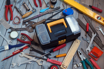 Wall Mural - Tool box on wooden floor, view from above.