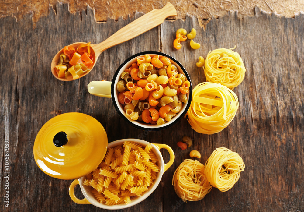 Various types of pasta in dishes on table