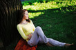© raisondtre - young girl sitting in the shade of a tree and enjoy the beauty of nature