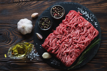 Wall Mural - Above view of raw fresh ground beef meat with condiments