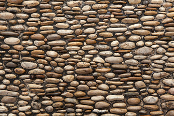 Cobbled pavement made of river rounded pebbles. Background textu