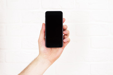 Aufkleber - Hand holding black phone