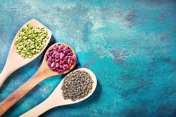 Wall Mural - various beans and lentils in wooden spoons