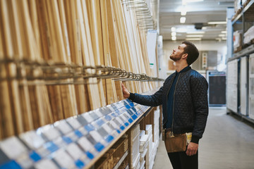 Carpenter selecting wood in a hardware store