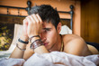 © theartofphoto - Shirtless sexy male model lying alone on his bed