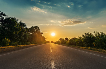 Wall Mural - sun in horizon over asphalt road