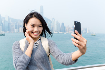 Wall Mural - Woman take seflie by cellphone in Hong Kong