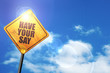 Yellow road sign with a blue sky and white clouds: have your say
