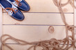 Blue Boat shoes with orange laces near rope on light wood background close up