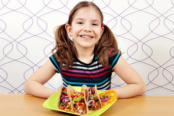 Wall Mural - happy little girl with tacos on plate