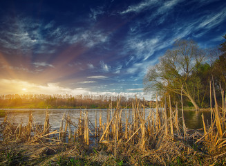 Wall Mural - Sunset over the lake in the village