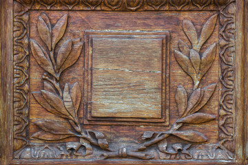 Wall Mural - Wood carving door with empty plate with laurel branch ornament