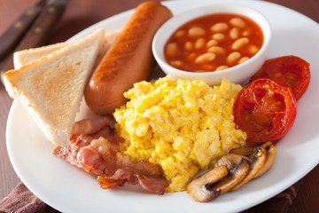 full english breakfast with scrambled eggs, bacon, sausage, bean