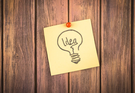 word idea on paper on a wooden background