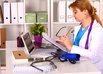 Wall Mural - Female doctor at the desk in the office