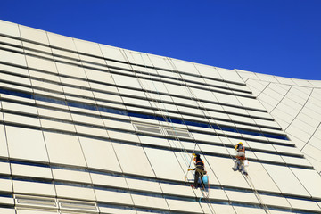 Workers wash the modern office building