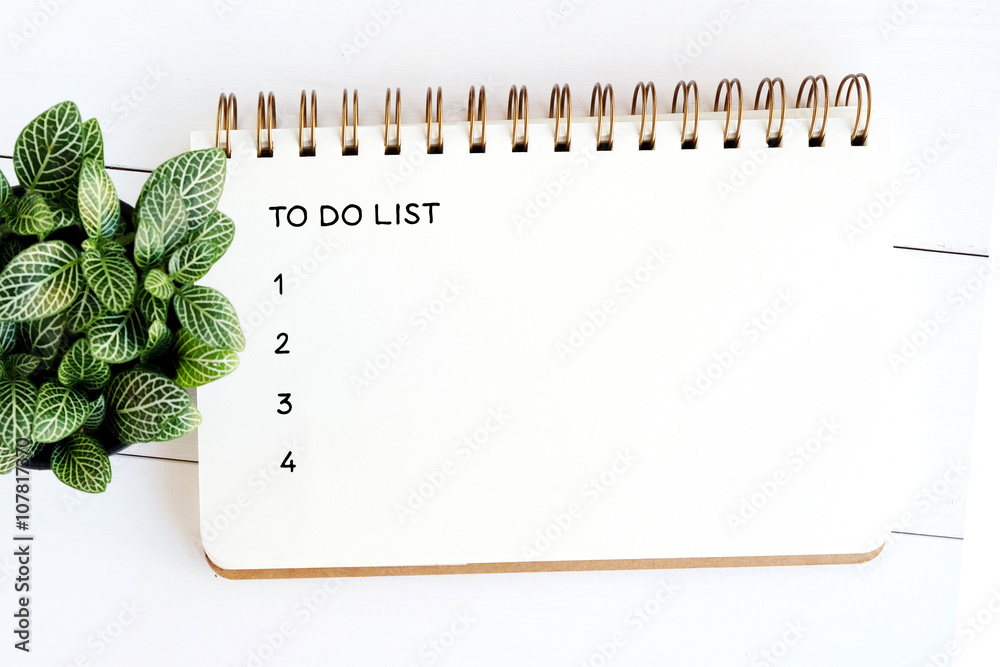 To do list on note book paper on white wood table background - obrazy, fototapety, plakaty 