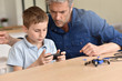 © goodluz - Dad and son playing with toy drone