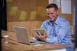 © WavebreakMediaMicro - Man using digital tablet in office