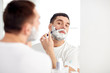 © Syda Productions - man shaving beard with razor blade at bathroom