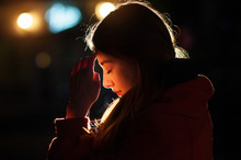 Closeup Portrait Of A Young  Woman Praying