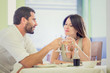 © ZoneCreative - Young romantic couple drink to each other at restaurant