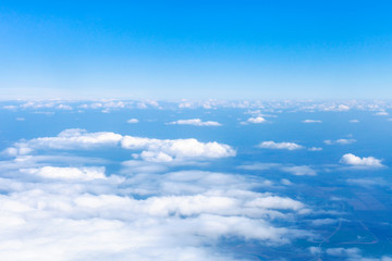 Wall Mural - above view clouds and earth horizon from airplane