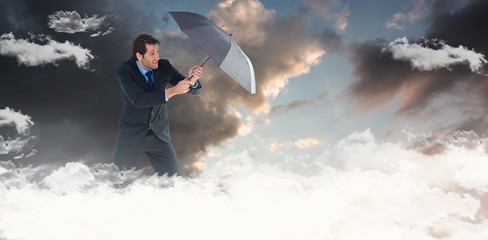 Sticker - Composite image of man holding umbrella to protect