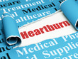 © Maksim Kabakou - Healthcare concept: red text Heartburn under the piece of  torn paper