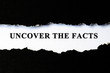 Uncover the facts concept phrase under torn paper