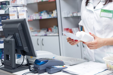 Wall Mural - Close up Hand of Woman Pharmacist with Prescription and Medicine