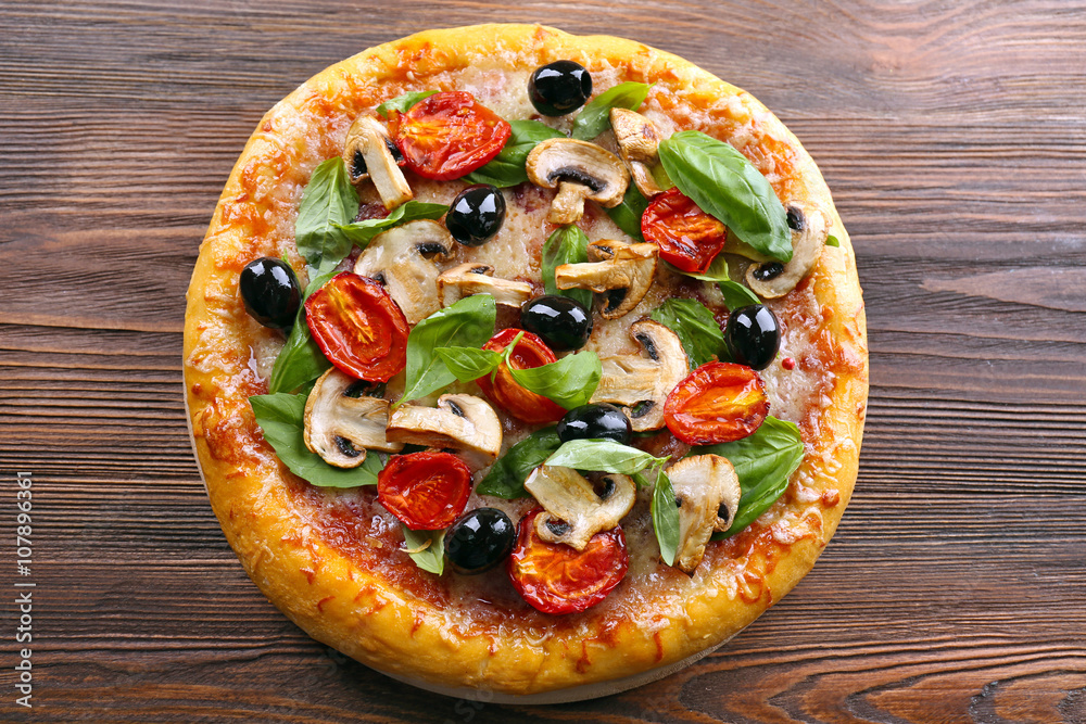 Delicious tasty pizza with ingredients on wooden table