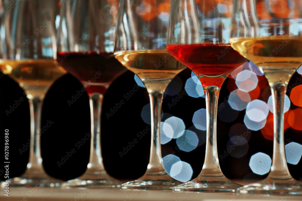 Many glasses of different wine in a row, close up