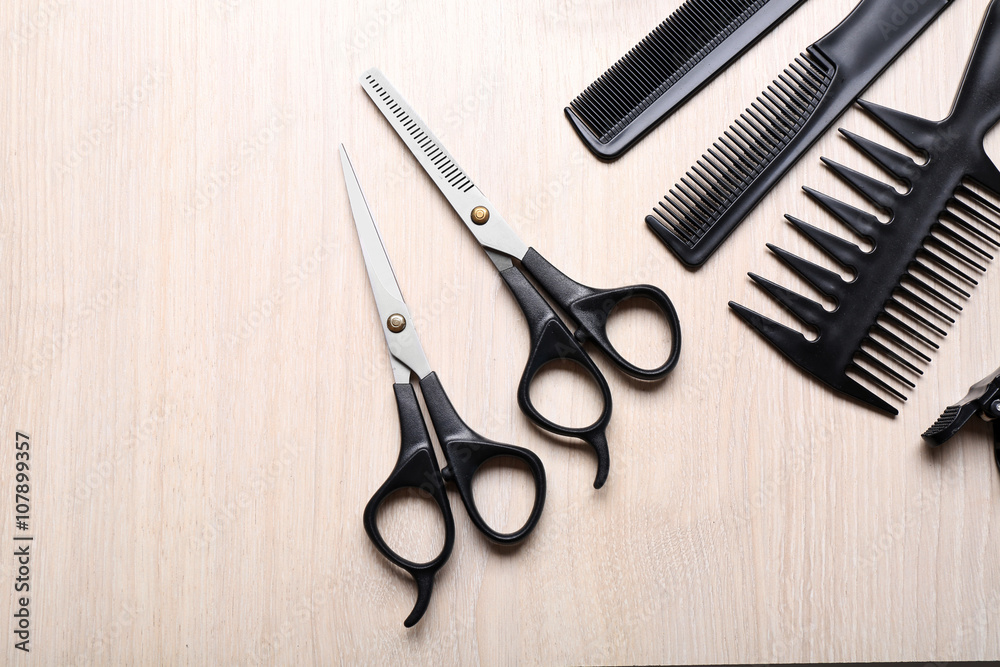 Barber set with tools on light wooden table