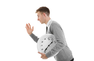 Handsome young man holding clock, isolated on white