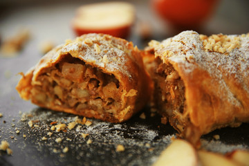 Powdered apple roll on a mat, closeup