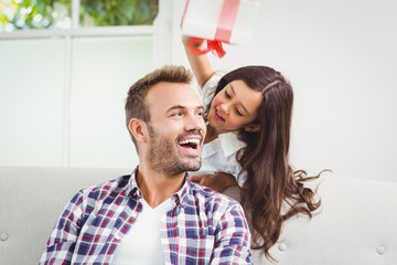 Wall Mural - Happy daughter and father with gift 