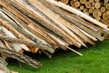 Wall Mural - firewood pile on green grass