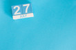 July 27th. Image of july 27 wooden color calendar on blue background. Summer day. Empty space for text